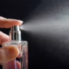 closeup of someone spraying perfume