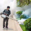 Mr. Mister technician using fogger mosquito treatment in a plaza