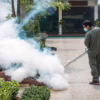 Mr. Mister technician spraying mosquito treatment in plaza